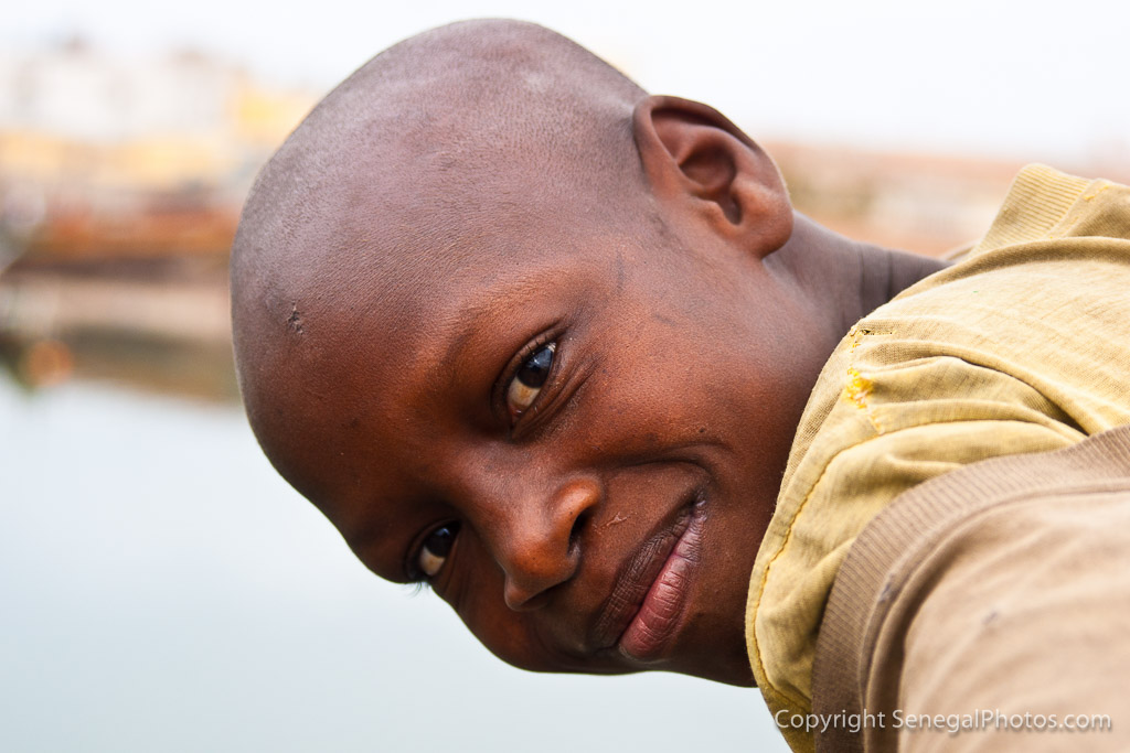 Homeless child trying his luck with passers by on the Pont Mustapha Malick ...